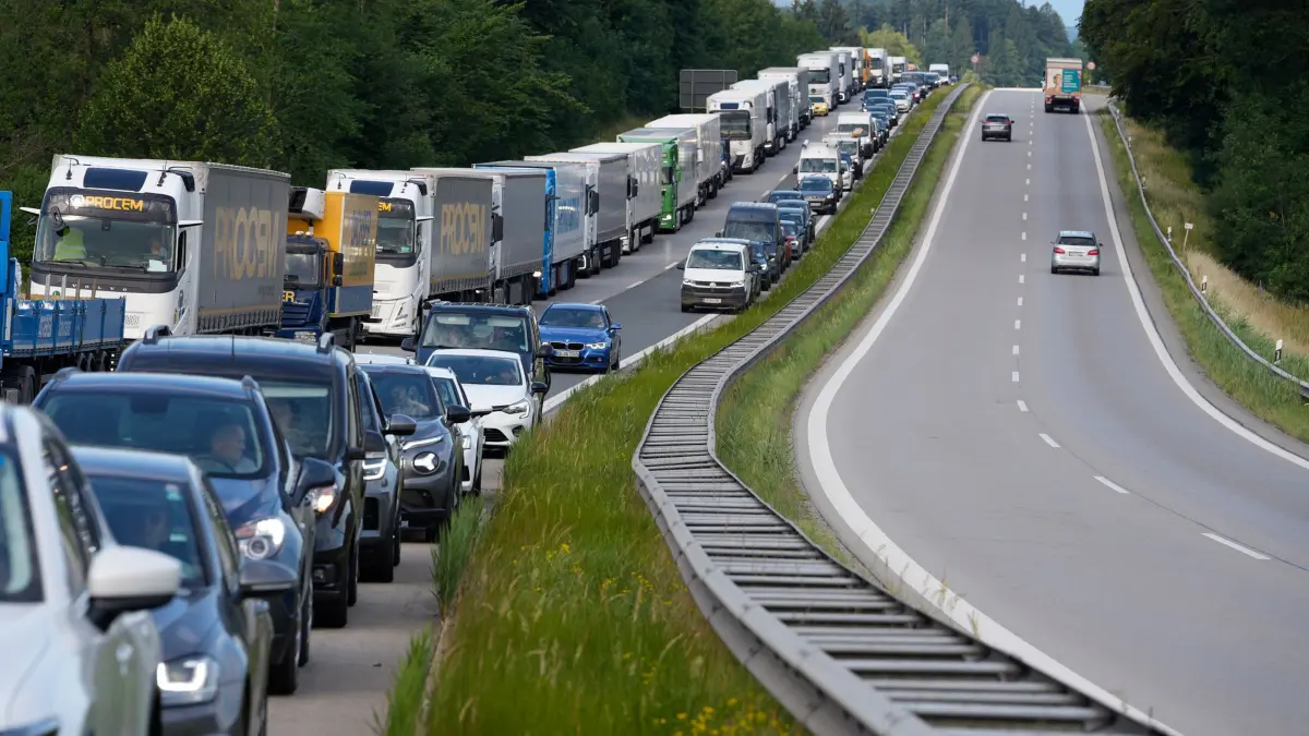 Waldbrand am Chiemsee: 29.06.2026, Bayern, Übersee: Fahrzeuge stauen sich auf der Autobahn A8 am Chiemsee, während einer Komplettsperre, da nahe der Autobahn Wald und Moor in Flammen stehen. Durch den aufsteigenden Rauch komme es zu Sichtbehinderungen, sagte ein Polizeisprecher. Die Feuerwehr warnt auch die Bevölkerung und bittet, Fenster und Türen geschlossen zu halten. Foto: Uwe Lein/dpa +++ dpa-Bildfunk +++