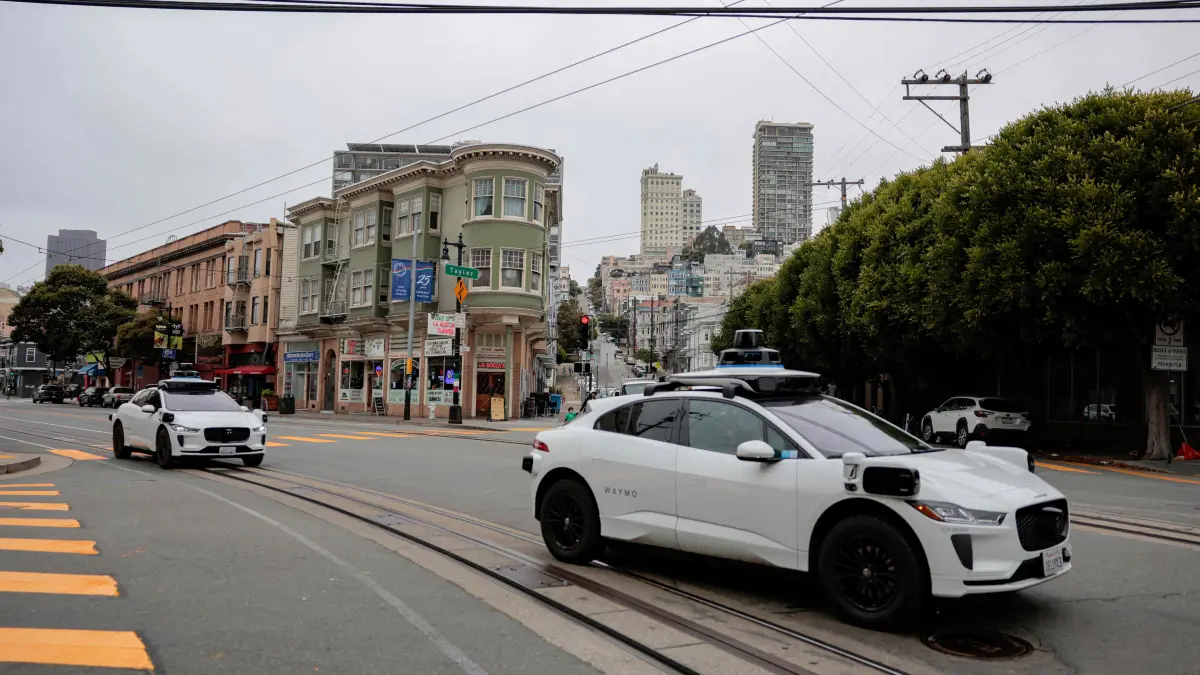 Autonomous Waymo Vehicles Navigate San Francisco: SAN FRANCISCO, CALIFORNIA - JULY 07: Waymo robotaxis drive in North Beach on July 07, 2026 in San Francisco, California. Several Waymo vehicles were towed after the company said their batteries died while they were stuck in heavy traffic during Fourth of July celebrations in San Francisco. Heather Diehl/Getty Images/AFP (Photo by Heather Diehl / GETTY IMAGES NORTH AMERICA / Getty Images via AFP)