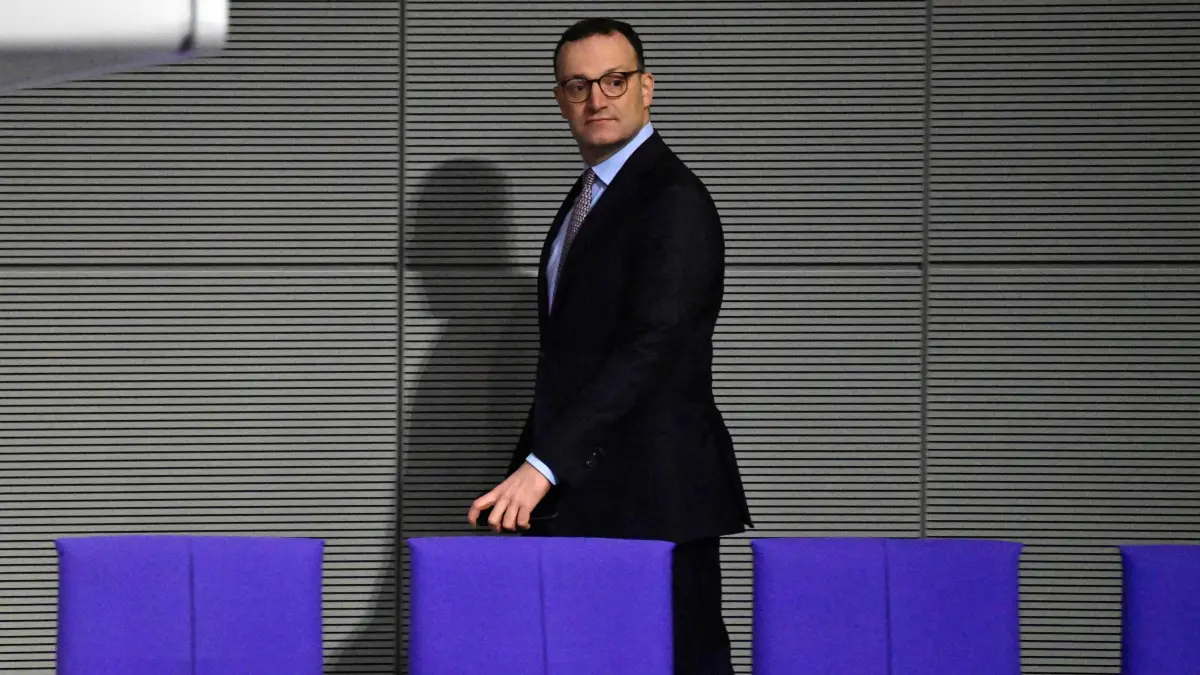 FILES-GERMANY-POLITICS-FAMILY-PARTIES-CDU: (FILES) Parliamentary group leader of Germany's Christian Democratic Union (CDU) party Jens Spahn walks through the plenary hall during a session at the Bundestag, Germany's lower house of parliament, in Berlin on December 5, 2025. Jens Spahn, a prominent figure in German Chancellor Friedrich Merz's centre-right party resigned his leadership post on July 18, 2026, party sources told AFP, amid controversy over his use of a surrogate mother in the US despite a ban on the practice in Germany. "In recent days, I have come to realise that my personal happiness in starting a family with my husband and becoming a father is incompatible with my political office," Jens Spahn, the chairman of the CDU's faction in parliament, wrote in a letter to colleagues that was obtained by AFP. (Photo by John MACDOUGALL / AFP)