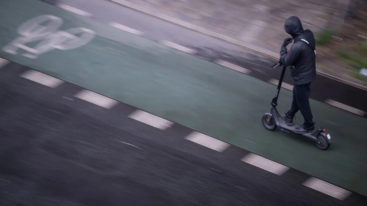 E-Scooter-Fahrer flüchtet mit Böller und fremder Bankkarte: ARCHIV - 02.05.2025, Berlin: Ein Mann fährt mit einem E-Scooter auf einem Fahrradweg. Mit illegalem Böller und einer fremden Bankkarte in der Tasche hat ein 40-jähriger Lippstädter unter Einfluss von Betäubungsmitteln versucht, auf einem E-Scooter einer Polizei-Kontrolle zu entkommen (zu dpa: «E-Scooter-Fahrer flüchtet mit Böller und fremder Bankkarte») Foto: Hannes P Albert/dpa +++ dpa-Bildfunk +++