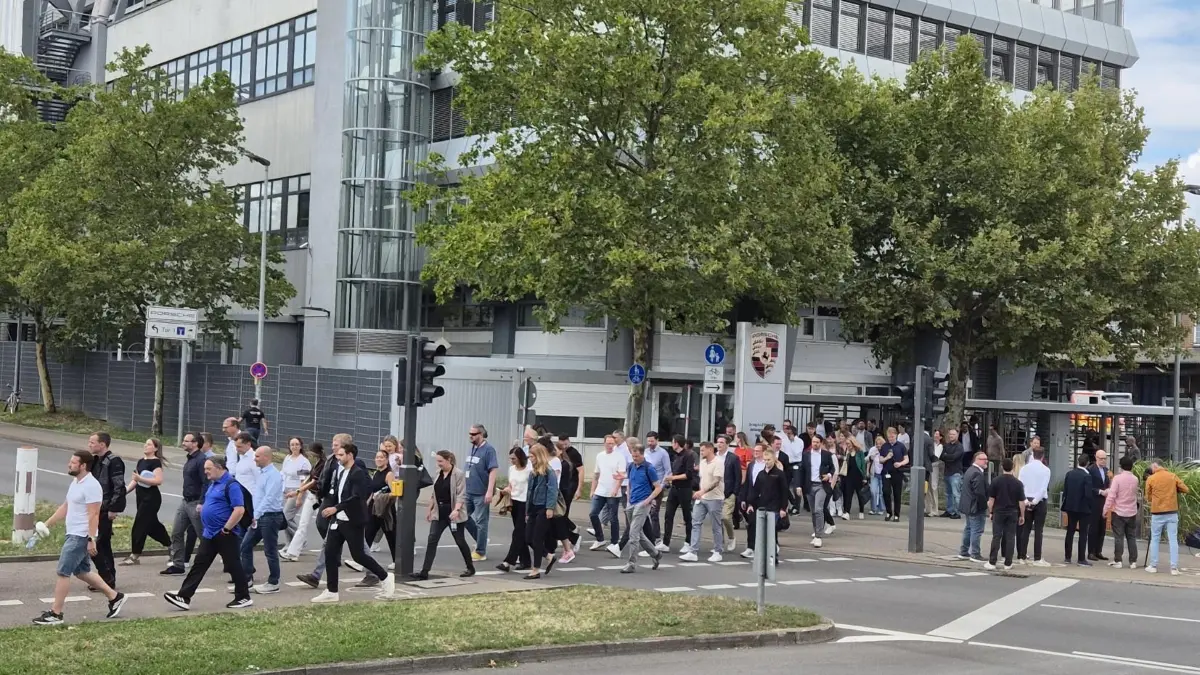 Viele Porsche-Beschäftigte blieben bis zum Ende der langen Betriebsversammlung und verließen das Gelände zusammen mit CEO Michael Leiters (rechts, im Interview).