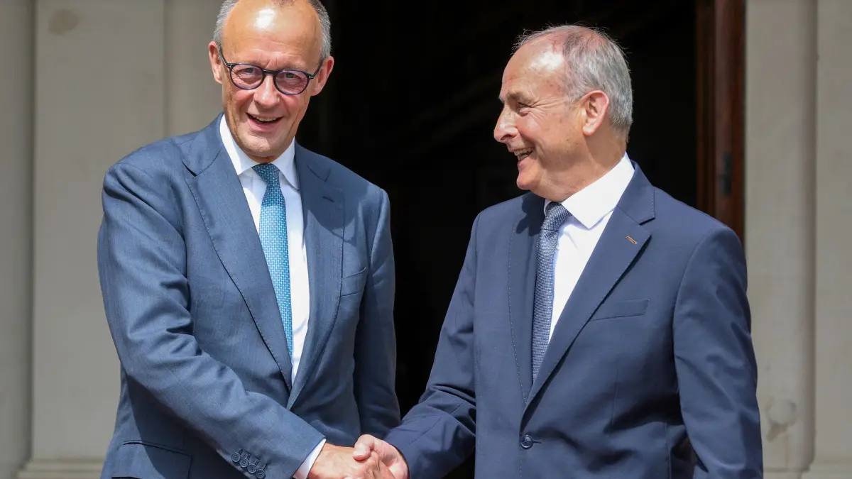 IRELAND-GERMANY-DIPLOMACY: Germany's Chancellor Friedrich Merz (R) is welcomed by Ireland's Prime Minister Micheal Martin upon his arrival at the official residence in Dublin on July 28, 2026. (Photo by Paul Faith / AFP)