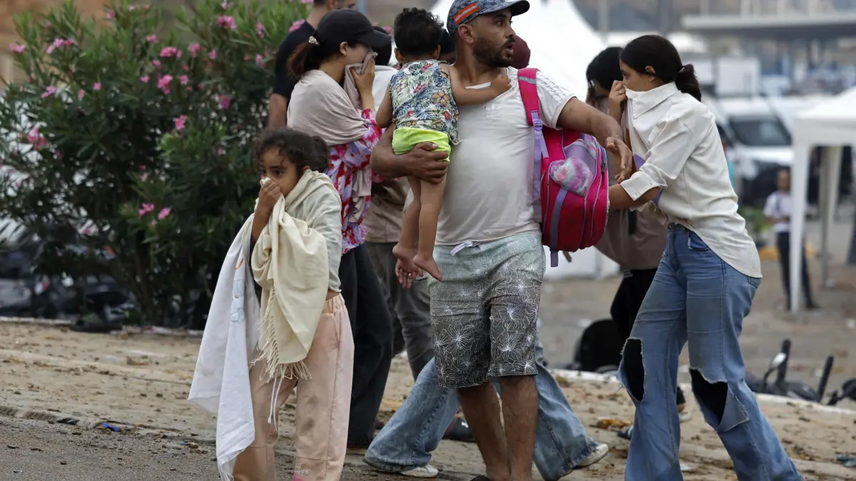 MOROCCO-SPAIN-MIGRATION: People react as they stand at the site of clashes near Fnideq, on the Morocco-Spain border, on July 31, 2026. Thousands of migrants crossed overnight from Morocco into Spain's north Africa's Ceuta enclave, a police source said on July 31, adding that it was impossible to estimate how many people in total. A total of 18 people died while attempting to reach the Spanish enclave, the source said. (Photo by Abdel Majid BZIOUAT / AFP)