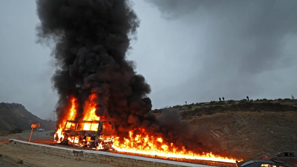 MOROCCO-SPAIN-MIGRATION: A vehicle burns at the site of clashes near Fnideq, on the Morocco-Spain border, on July 31, 2026. Thousands of migrants crossed overnight from Morocco into Spain's north Africa's Ceuta enclave, a police source said on July 31, adding that it was impossible to estimate how many people in total. A total of 18 people died while attempting to reach the Spanish enclave, the source said. (Photo by Abdel Majid BZIOUAT / AFP)