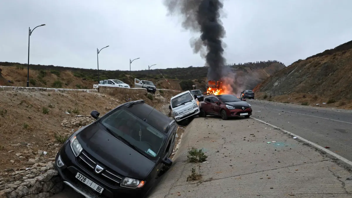 MOROCCO-SPAIN-MIGRATION: Damaged vehicles are pictured at the site of clashes near Fnideq, on the Morocco-Spain border, on July 31, 2026. Thousands of migrants crossed overnight from Morocco into Spain's north Africa's Ceuta enclave, a police source said on July 31, adding that it was impossible to estimate how many people in total. A total of 18 people died while attempting to reach the Spanish enclave, the source said. (Photo by Abdel Majid BZIOUAT / AFP)