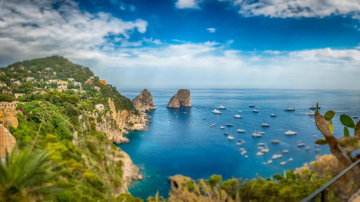 Panoramic view over Marina Piccola and Faraglioni: coastal wonders in Mediterranean splendor of the island of Capri, Italy. Tilt-shift effect applied xkwx beach beautiful blue capri capri island capri italy cliffs coast europe faraglioni green horizon island italian italy landmark landscape mediterranean mountain nature outdoor panoramic sea sky summer tourism travel trip vacation view