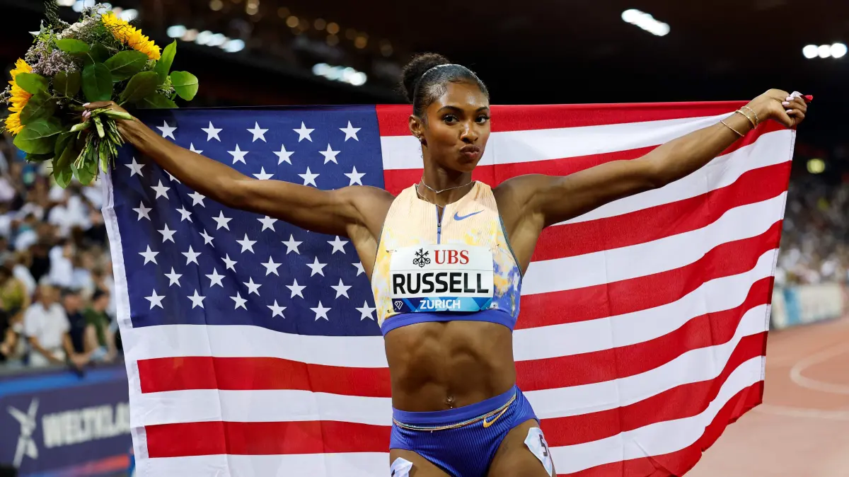 ATHLETICS-DIAMOND-SUI: US' Masai Russell celebrates after winning and breaking the world record in the women's 100m hurdles during the IAAF Diamond League athletics meeting, at the Letzigrund Stadium, in Zurich on August 27, 2026. (Photo by Stefan Wermuth / AFP)
