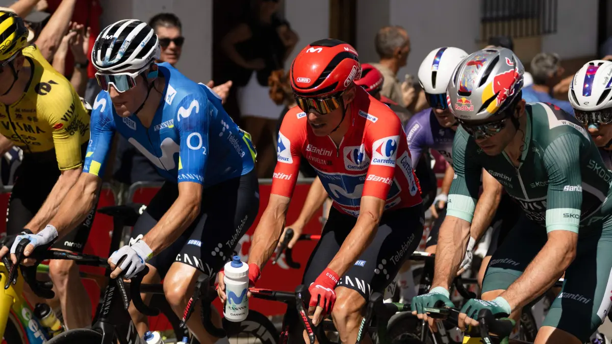 CYCLING-ESP-VUELTA: (From L) Team Movistar's Spanish rider Pablo Castrillo, overall ranking leader Team Movistar's Spanish rider Enric Mas, and points ranking leader Team Visma-Lease a bike's Belgian rider Wout van Aert ride at the start of the 16th stage of the Vuelta a Espana 2026 cycling tour, a 181,1 km race between Cortegana and the Monastery of Santa Maria de la Rabida in Palos de la Frontera, on September 8, 2026. (Photo by JORGE GUERRERO / AFP)