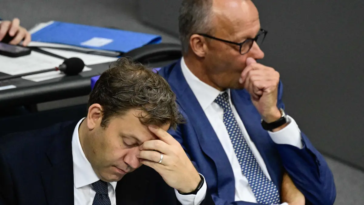 GERMANY-POLITICS-BUDGET: German Finance Minister and Vice Chancellor Lars Klingbeil (L) and German Chancellor Friedrich Merz look on after Merz delivered his speech on the 2027 Budget bill at the Bundestag, the lower house of parliament, in Berlin, on September 9, 2026. (Photo by John MACDOUGALL / NTB / AFP)