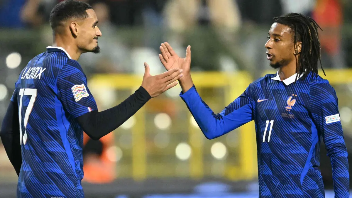FBL-EUR-NATIONS-BEL-FRA: France's defender #17 Maxence Lacroix (L) and France's midfielder #11 Michael Olise (R) celebrate at the end of the UEFA Nations League Group A1 football match between Belgium and France at King Baudouin Stadium in Brussels on September 28, 2026. (Photo by NICOLAS TUCAT / AFP)