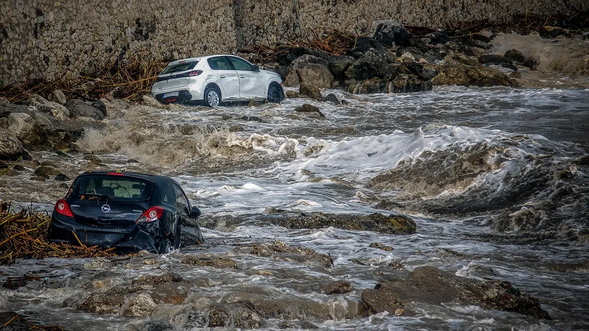 GREECE-WEATHER-CLIMATE-FLOODS: Cars swept away by floodwaters are pictured as torrential rain and storms hit the Dodecanese, in the area of Stegna, near the village of Archangelos, on the Greek island of Rhodes on October 14, 2026. A 62-year-old man died in the area after his car was swept into the sea, authorities said, as the mayor requested that the island be declared in a state of emergency. (Photo by Eurokinissi / AFP)