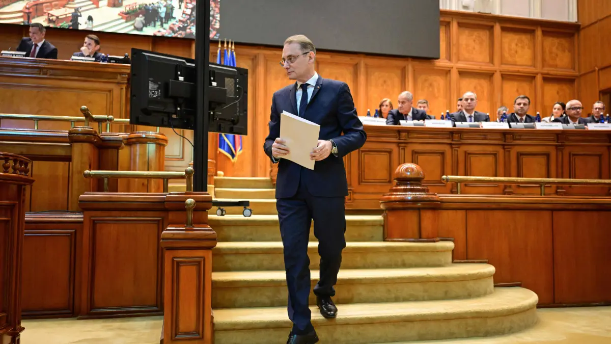 ROMANIA-POLITICS-GOVERNMENT: Romania's prime minister-designate Luca Niculescu is seen at the Romanian Parliament in Bucharest during a plenary session on October 20, 2026. The 55-year-old diplomat and former ambassador is attempting to form a hybrid administration composed of the centre-left Social Democratic Party (PSD) and independent technocrats. The vote aims to end a damaging five-month political deadlock that has frozen key economic decisions and strained investor confidence in the EU and NATO member state.
Niculescu is the fourth candidate to try and form a government since a pro-European coalition government collapsed in May, sparking uncertainty. (Photo by Daniel MIHAILESCU / AFP)