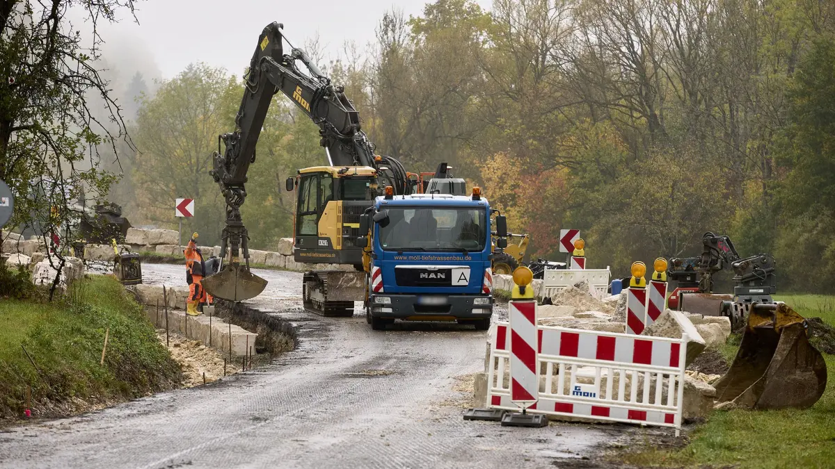 Sanierung der K1448 zwischen Bad Ditzenbach und Auendorf. Für die Sanierungsarbeiten ist die K1448 im Zeitraum vom 05.10.2026 bis Mitte Dezember für den verkehr gesperrt. Das Bild zeigt Bauarbeiten kurz vor Auendorf, wo gerade eine Steinmauer gesetzt wird.
